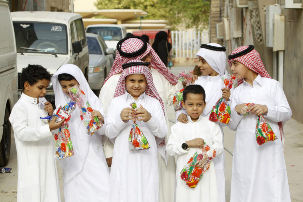 Traditional Saudi Eid-ul-Fitr family gathering with food and Eidi gifts